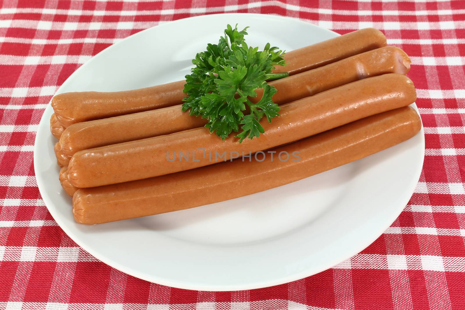 stacked Wiener sausages with parsley on a napkin