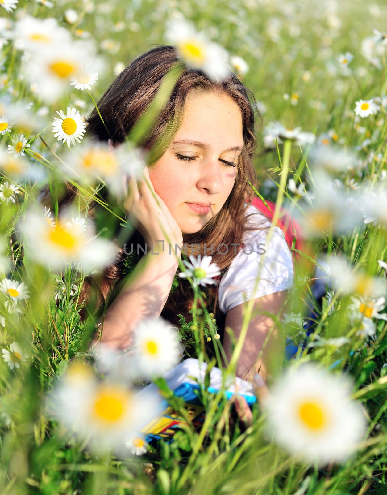 reading girl in field by Reana