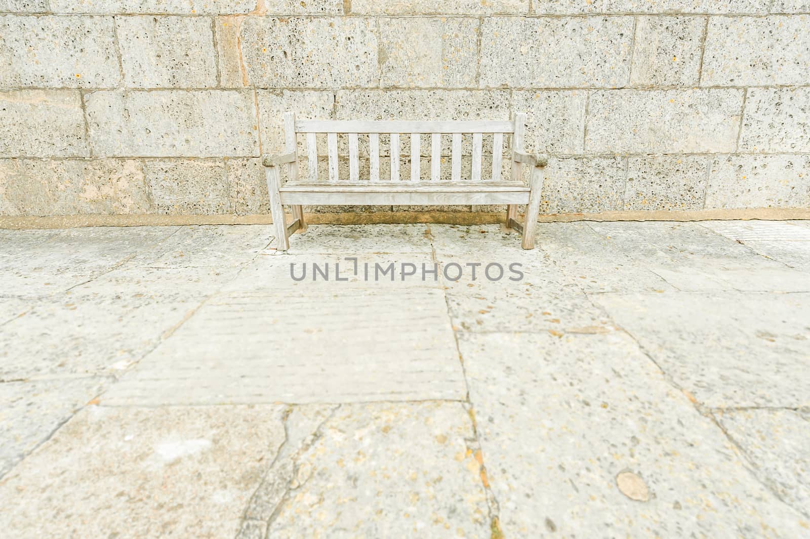 wooden park bench camouflaged by surrounding concrete blocks