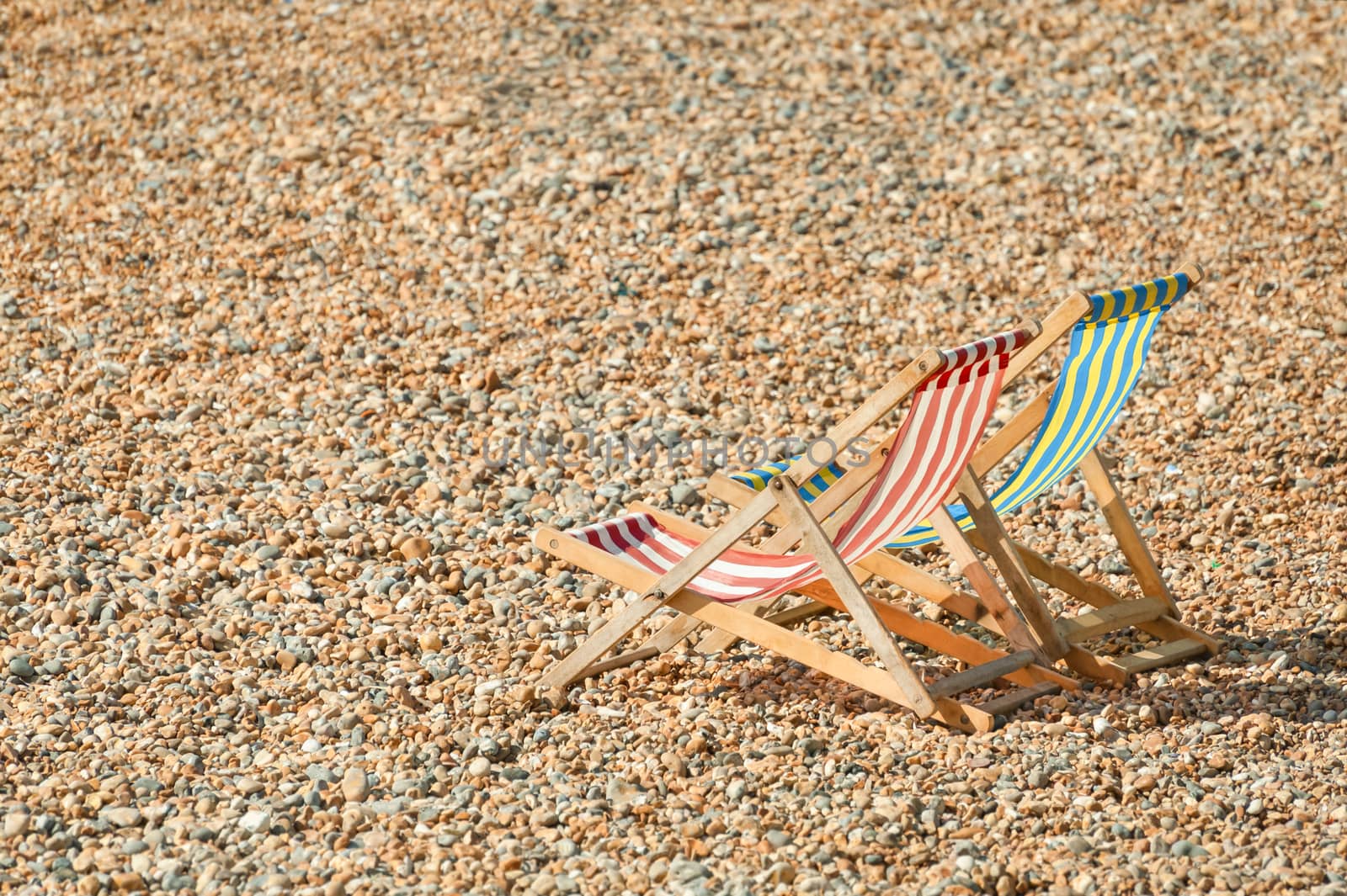 deckchairs on a beach by nelsonart