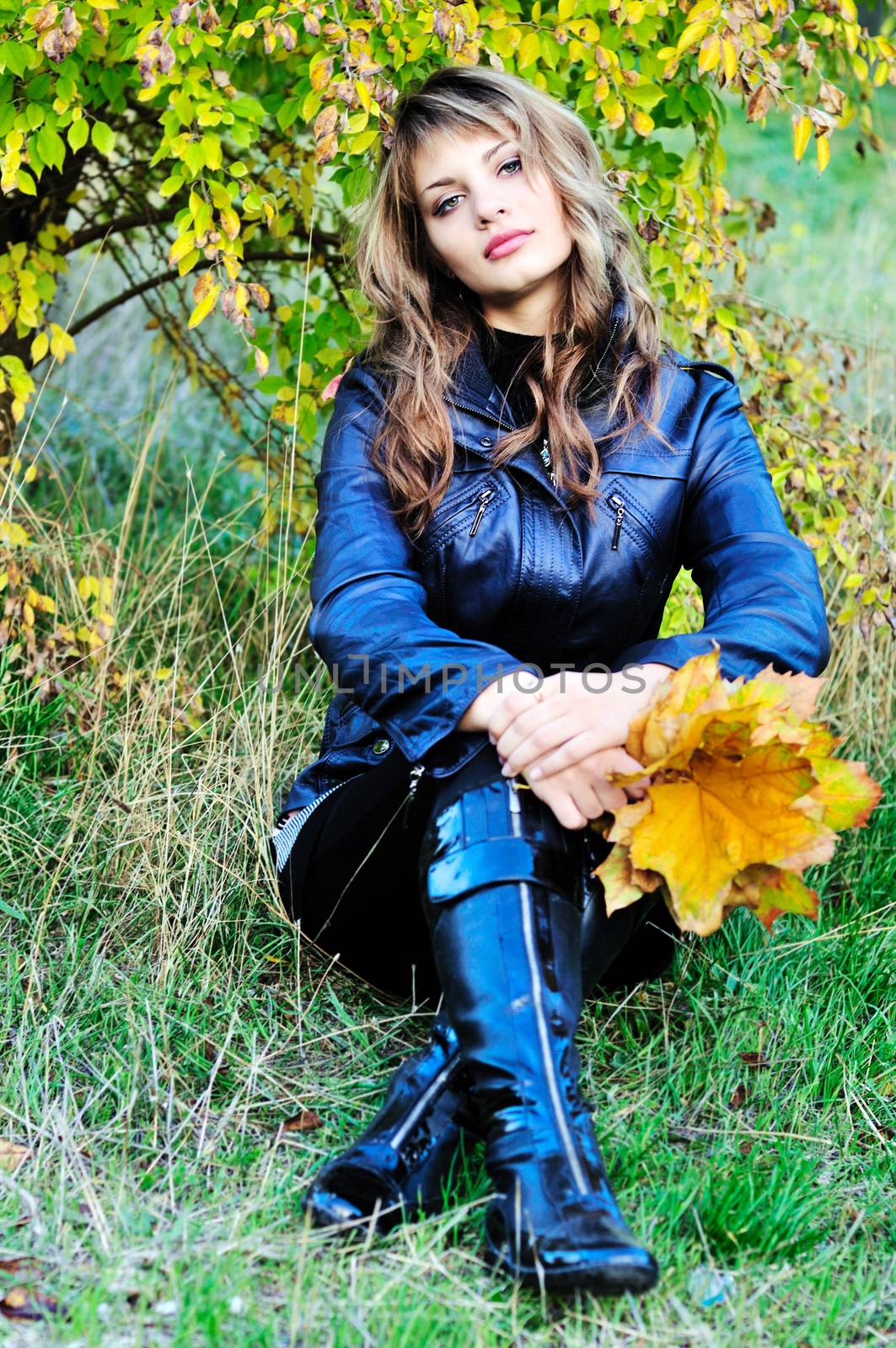 autumn beauty sitting teen girl holding leaves