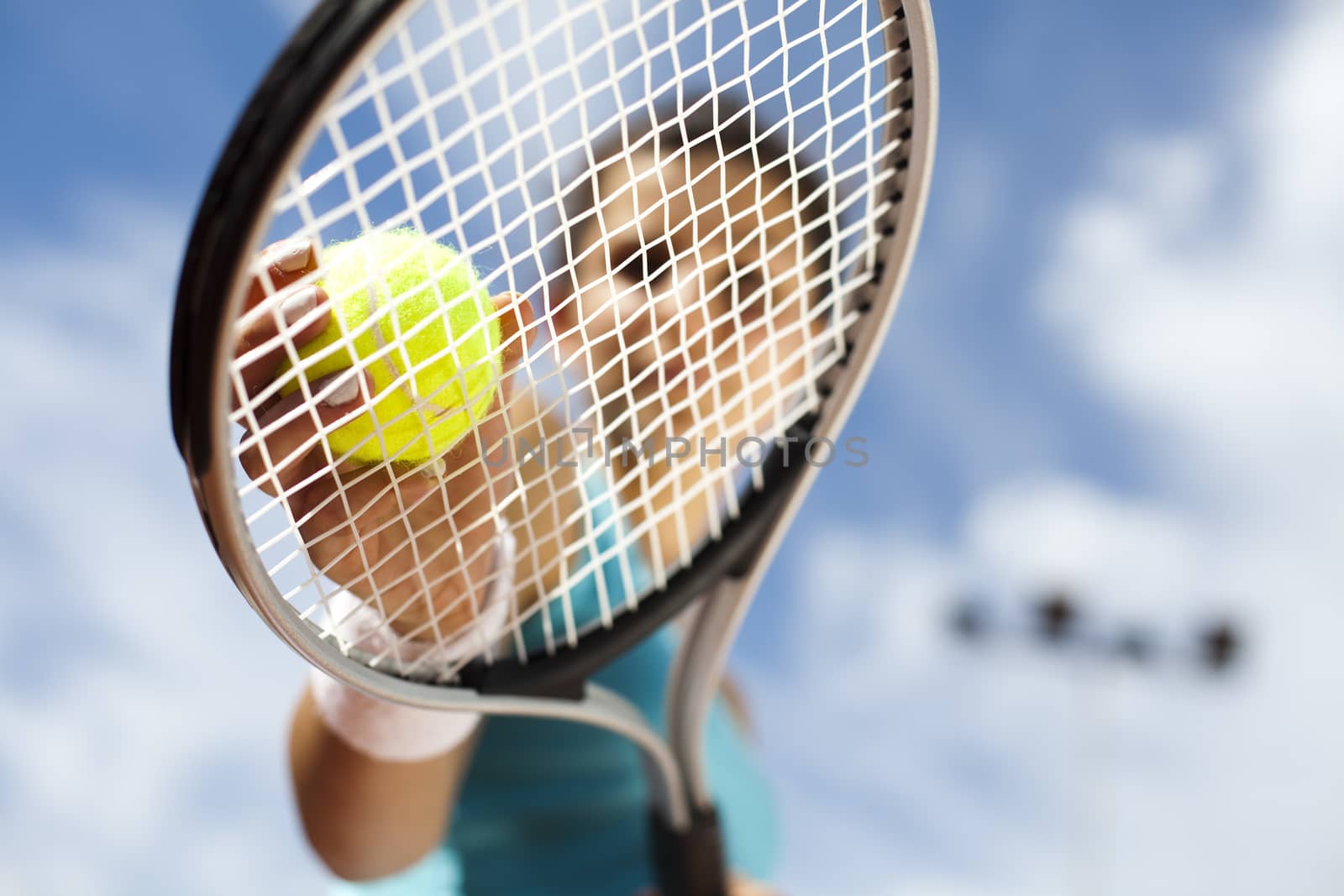 Girl playing tennis on the court by JanPietruszka