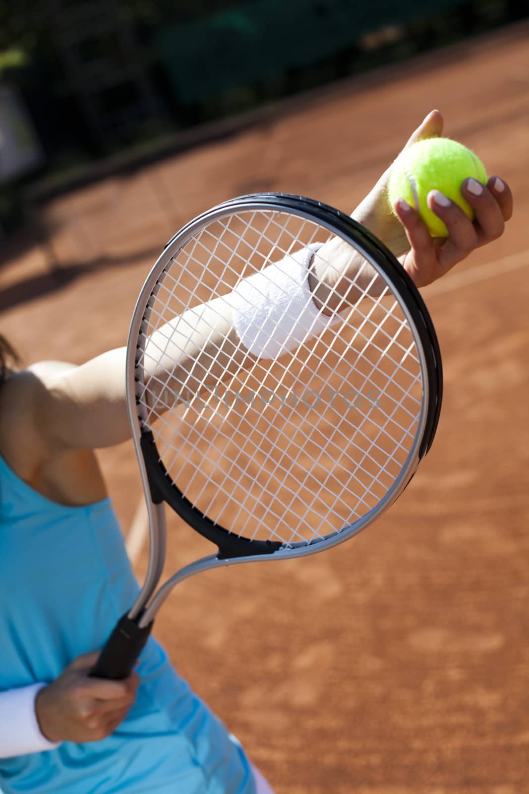 Woman playing tennis in summer by JanPietruszka