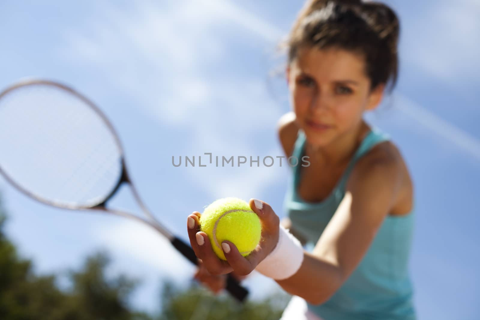 Woman playing tennis in summer by JanPietruszka