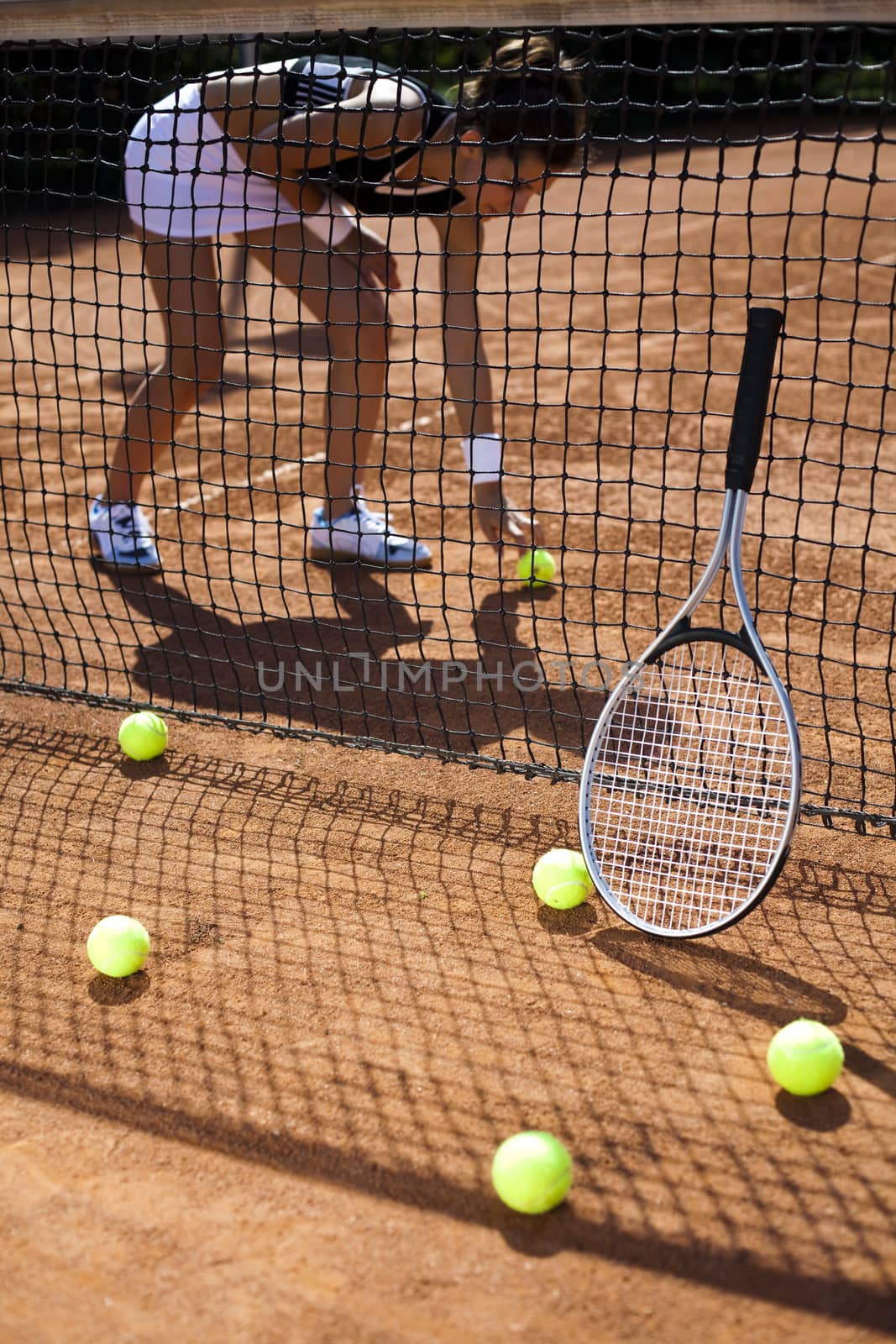 Young woman playing tennis, summertime saturated theme