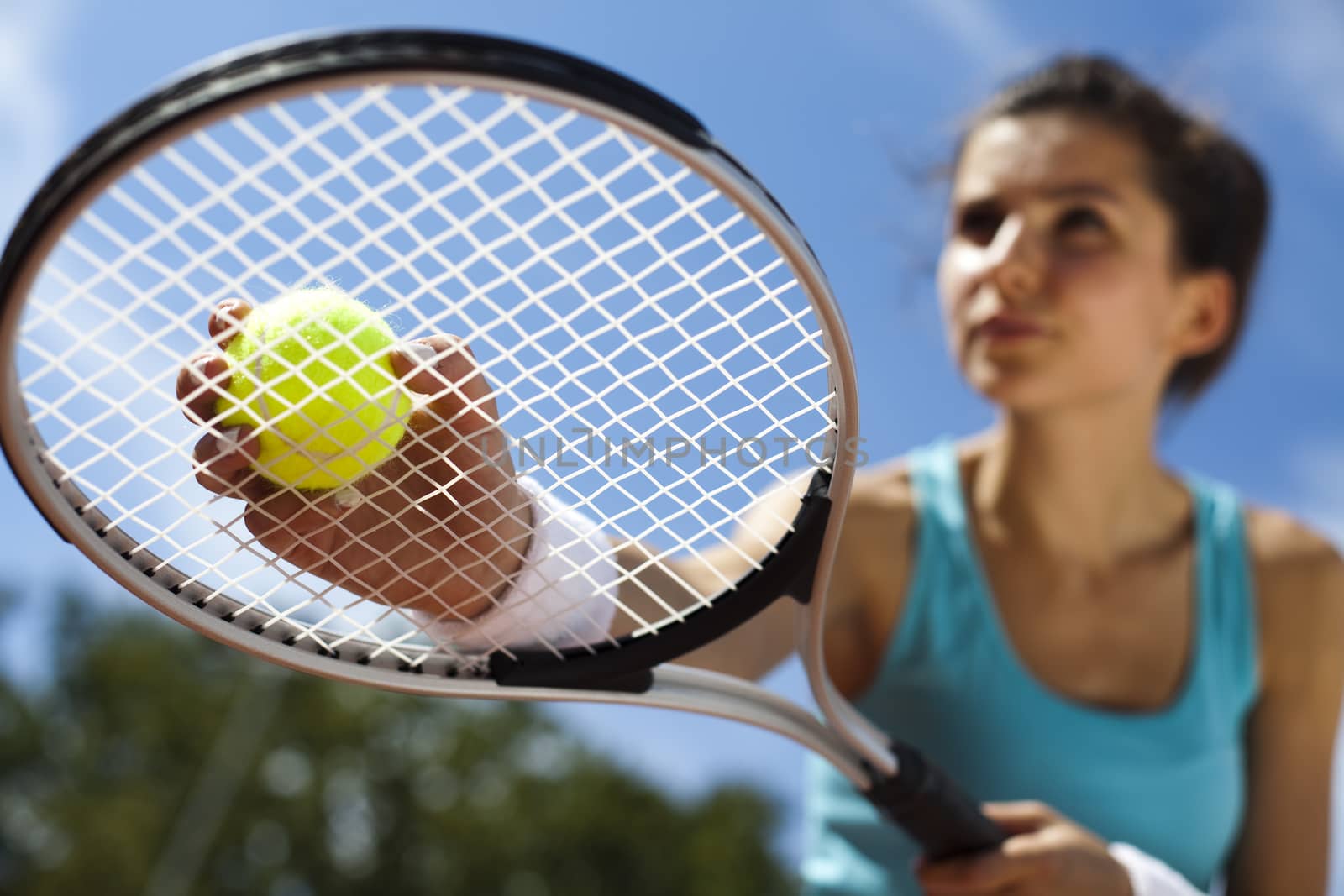 Young woman playing tennis, summertime saturated theme by JanPietruszka