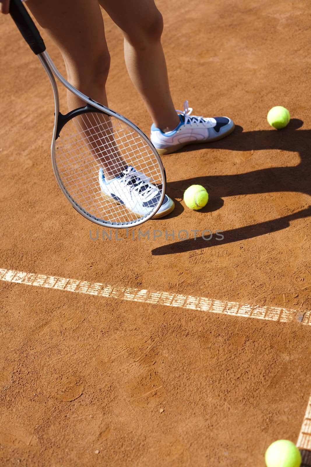 Young woman tennis player on the court by JanPietruszka