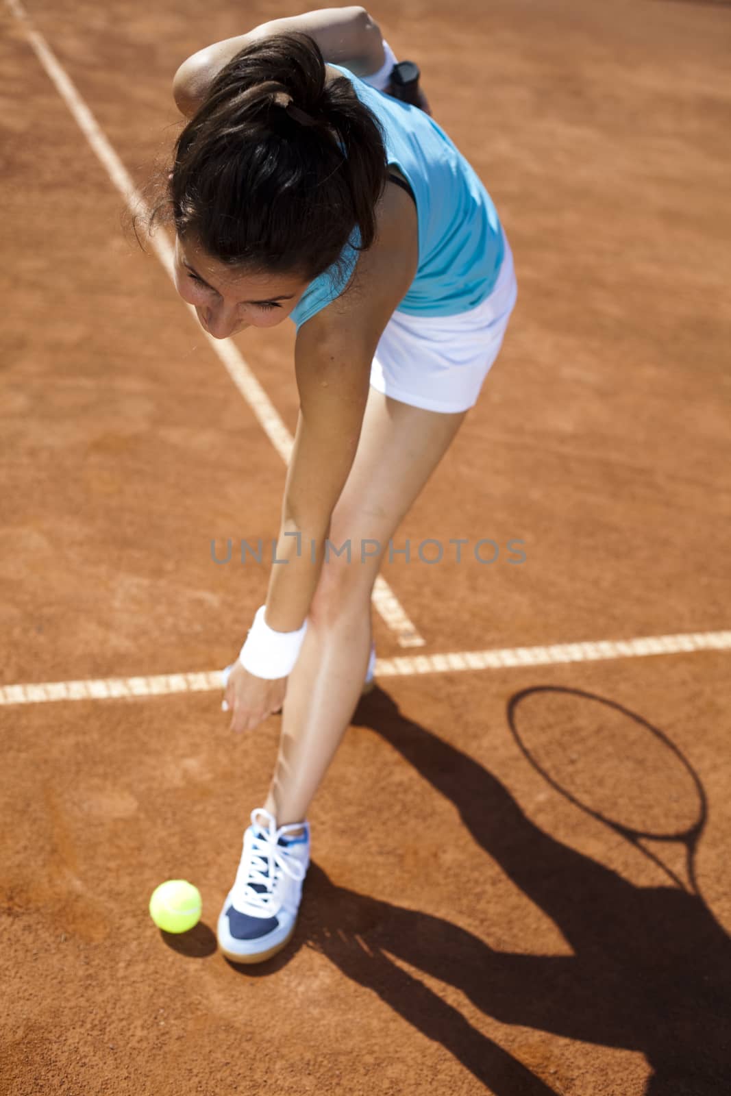 Young woman tennis player on the court by JanPietruszka