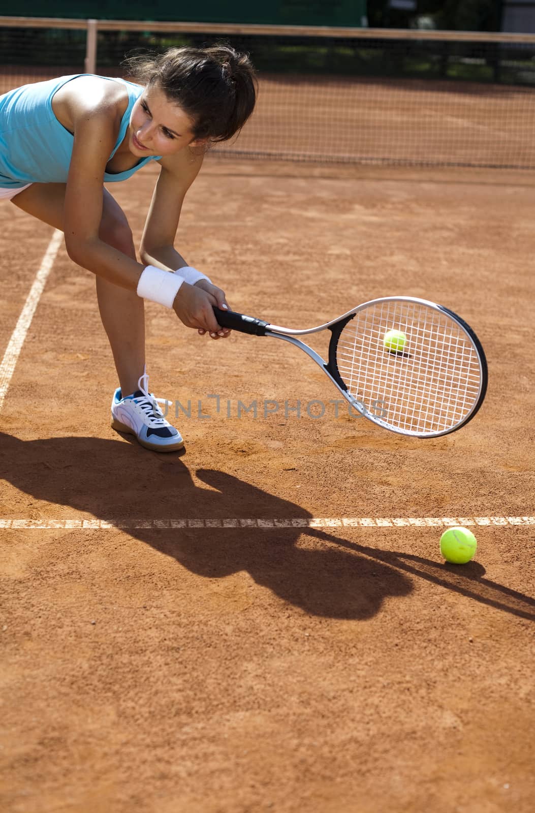 Young woman tennis player on the court