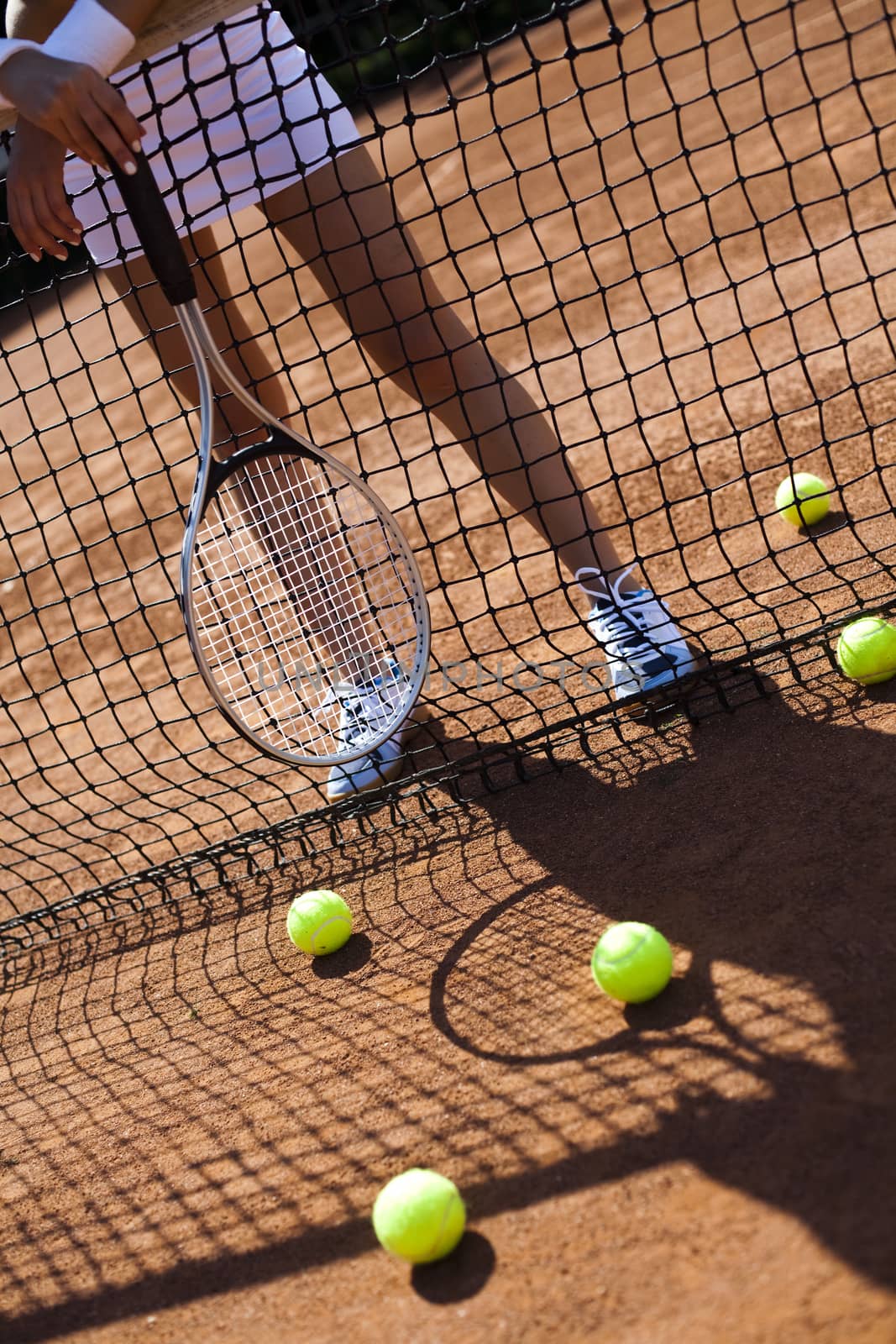 Young woman tennis player on the court by JanPietruszka