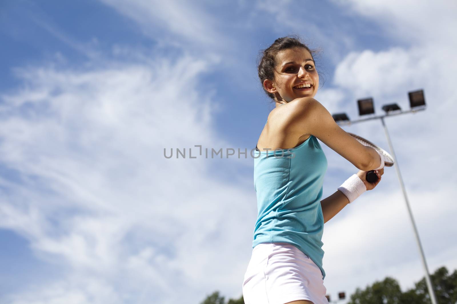 Girl playing tennis on the court