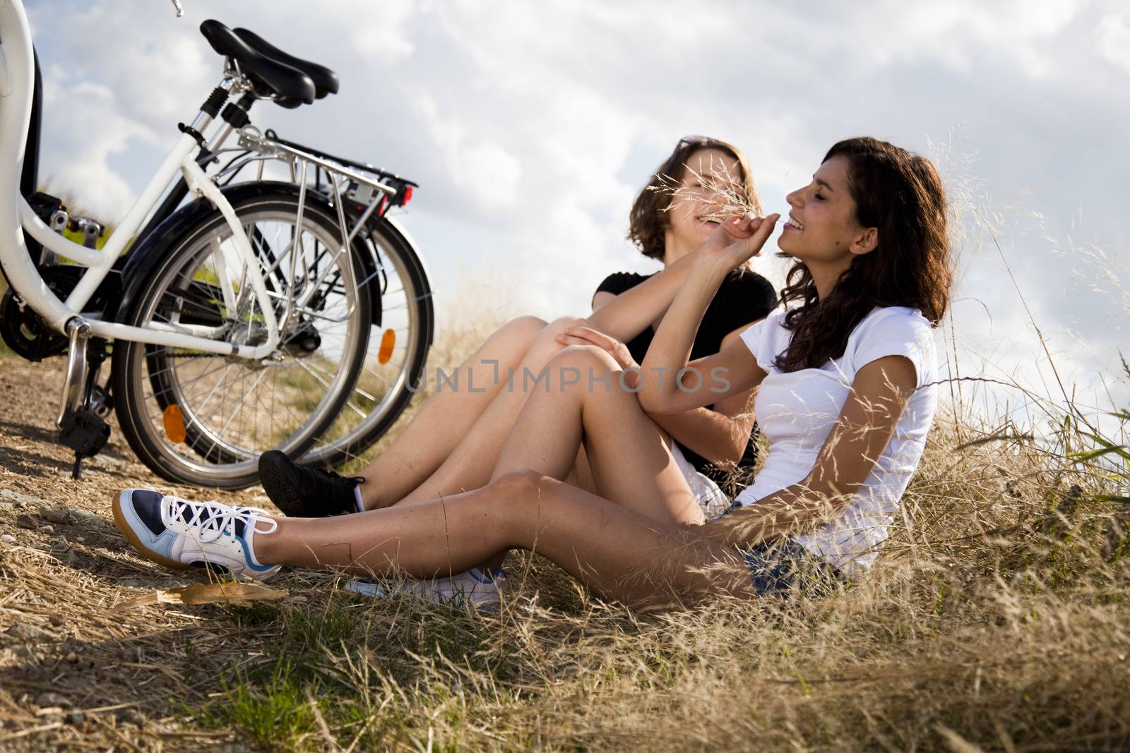 Young woman riding a bicycle by JanPietruszka