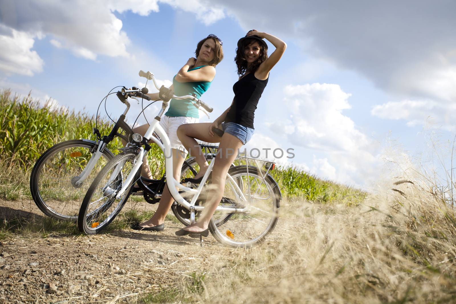 Young woman riding bike, summer free time spending by JanPietruszka