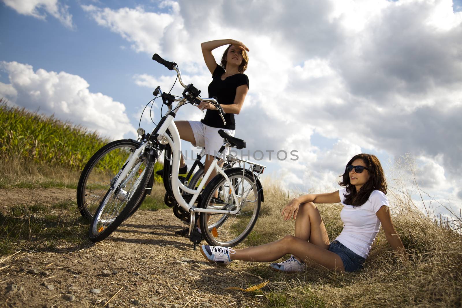 Woman riding bicycle, summer free time spending by JanPietruszka