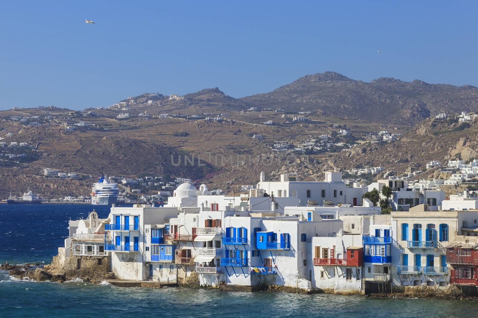 A corner of Mykonos seen from the sea with many seaside houses 