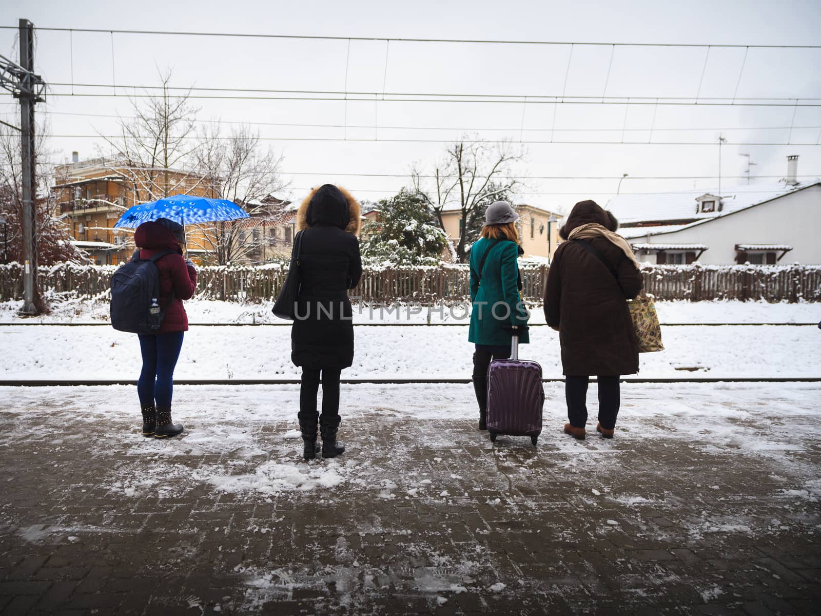 Four women with totally different styles are waiting for the train in Monza, Italy