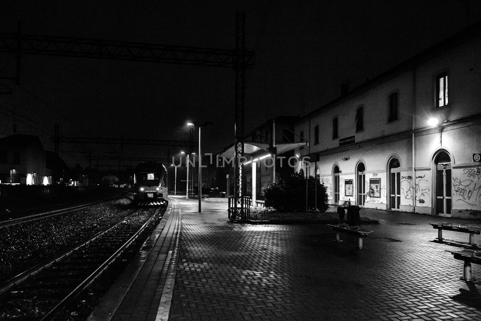 A train station in Monza, Italy during a dark night.