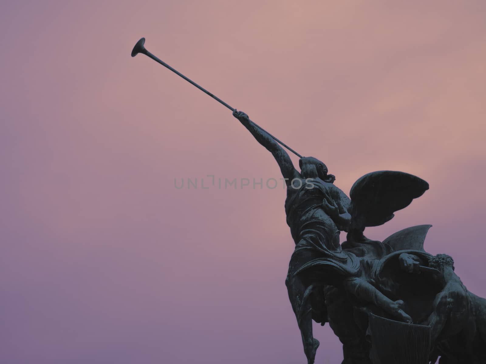 Statue of an winged angel playing the victory with its trumper, Monza, Italy