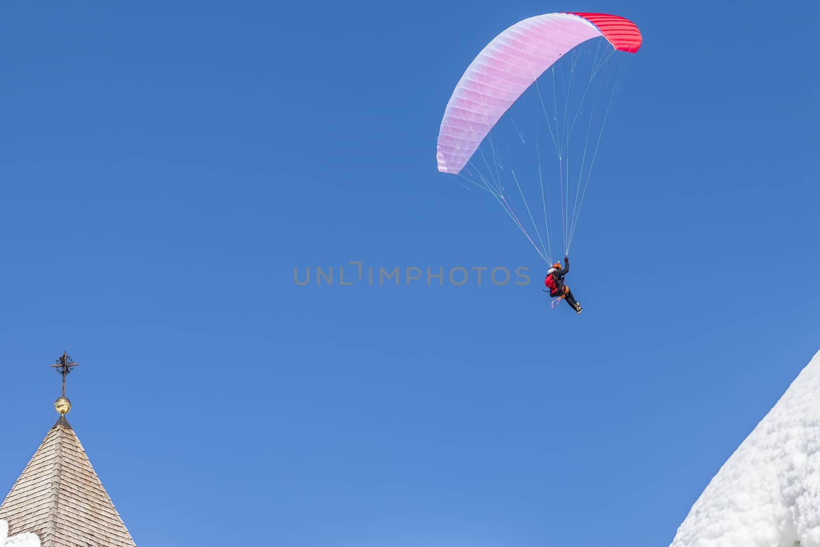 A man having fun with a paraglider. Italy