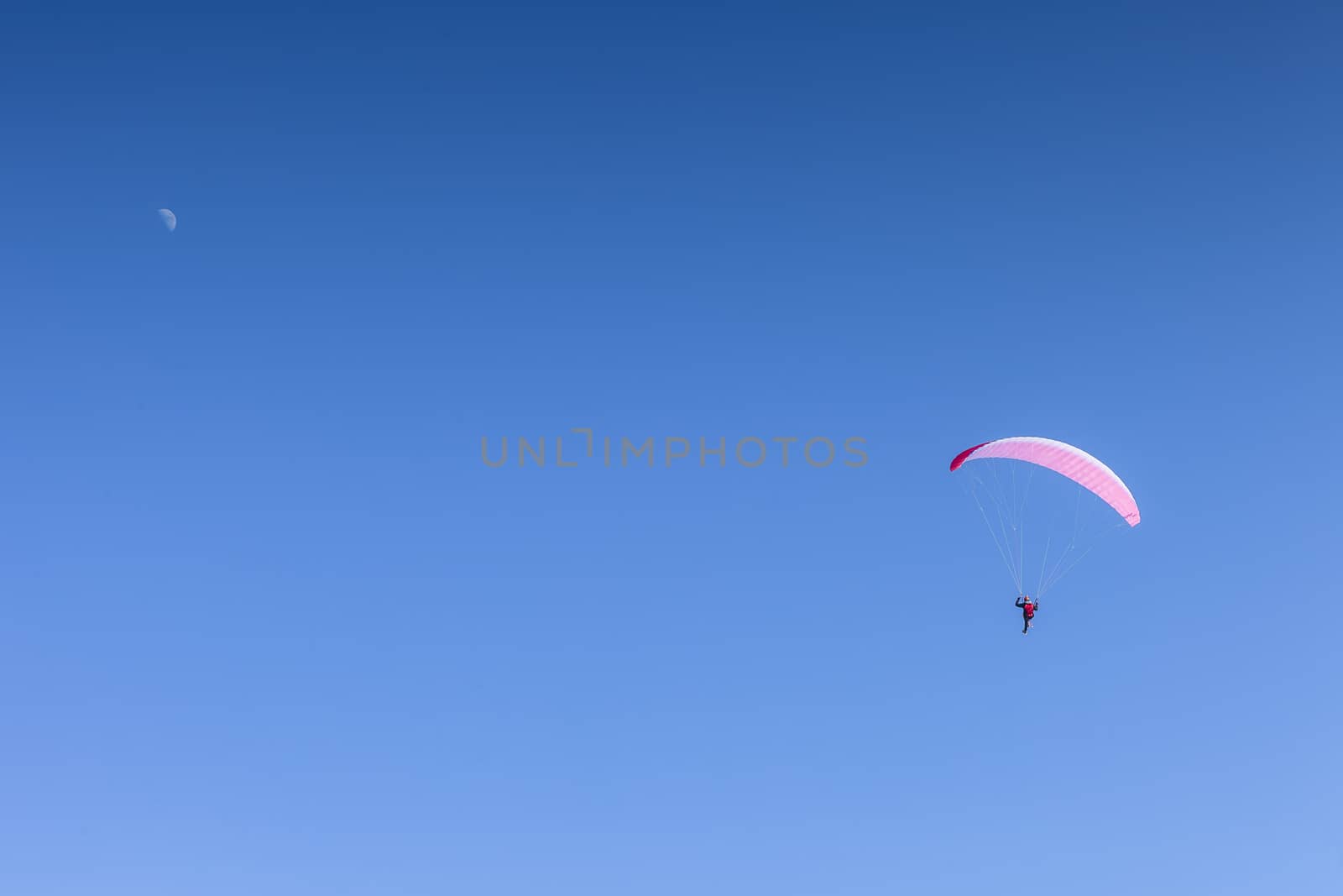 A man having fun with a paraglider. Italy