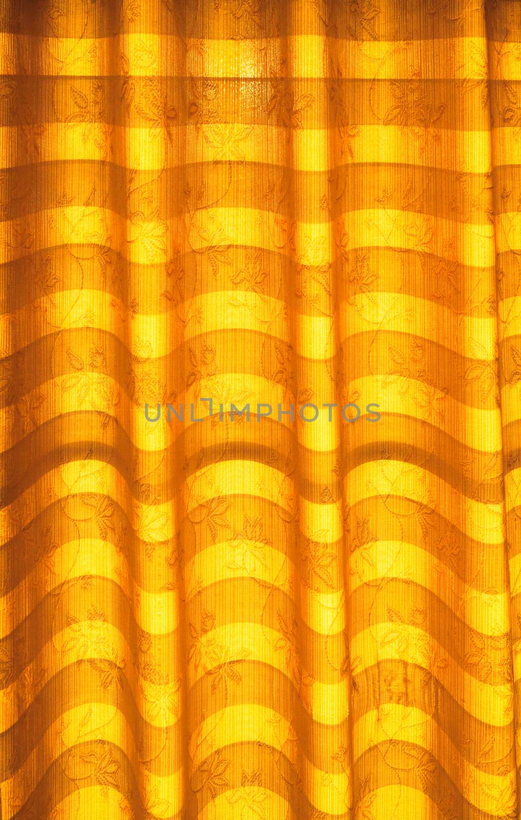 Warm tone blinds or curtains and abstract natural sunlight .