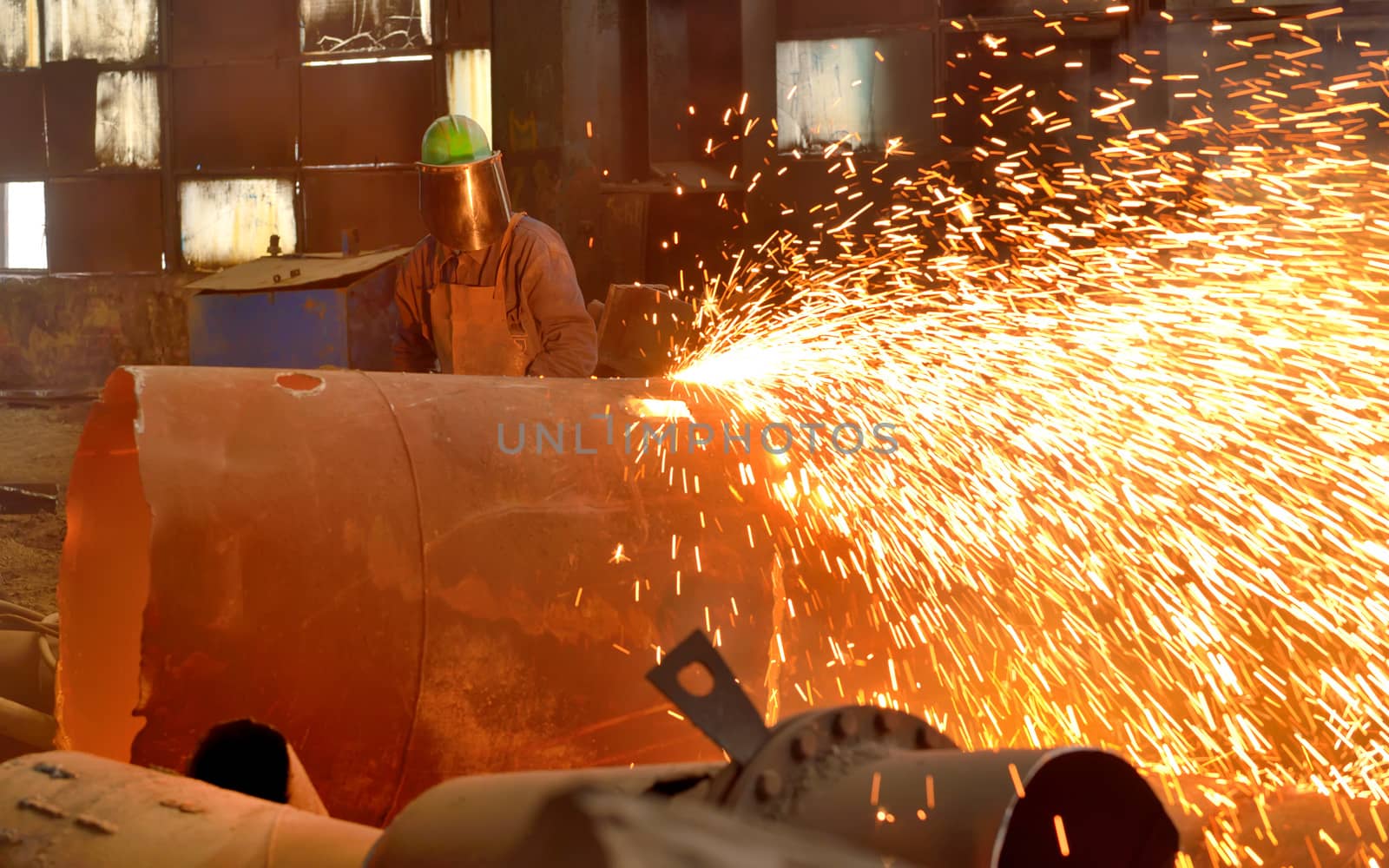 worker using torch cutter to cut through metal