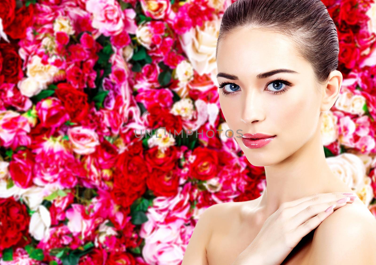 Beautiful woman on a floral background with red and white roses by Nobilior