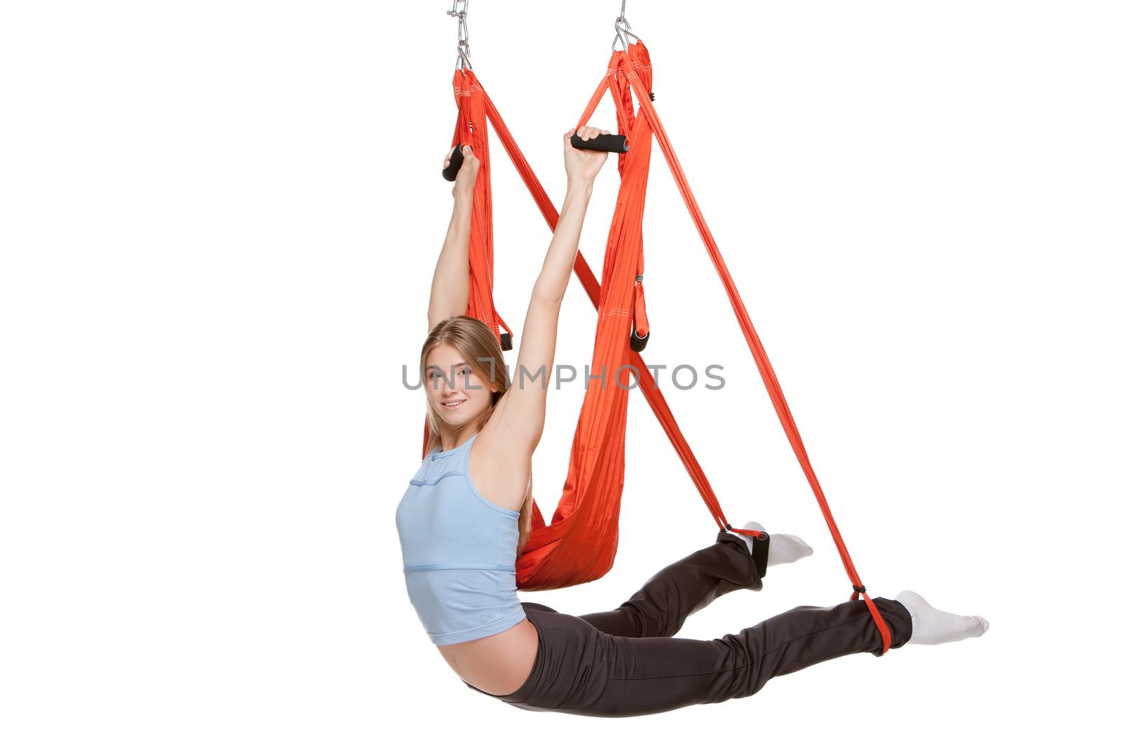 Young woman doing anti-gravity aerial yoga in  red hammock on a seamless white background. by master1305