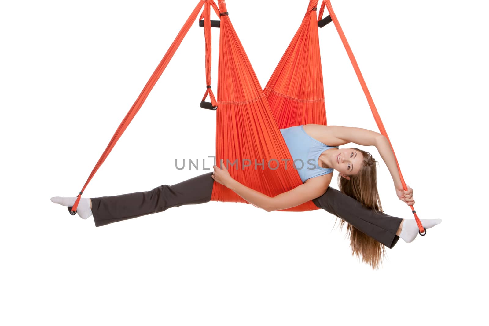 Young woman making antigravity yoga exercises in stretching twine by master1305