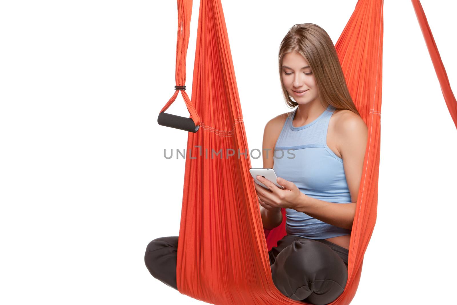 Young woman sitting in hammock for anti-gravity aerial yoga by master1305