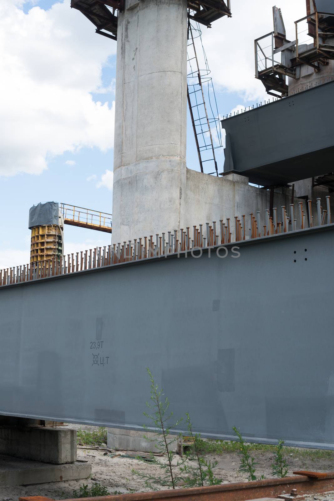 Bridge construction site with concrete piers already finished and still in the metal formwork.