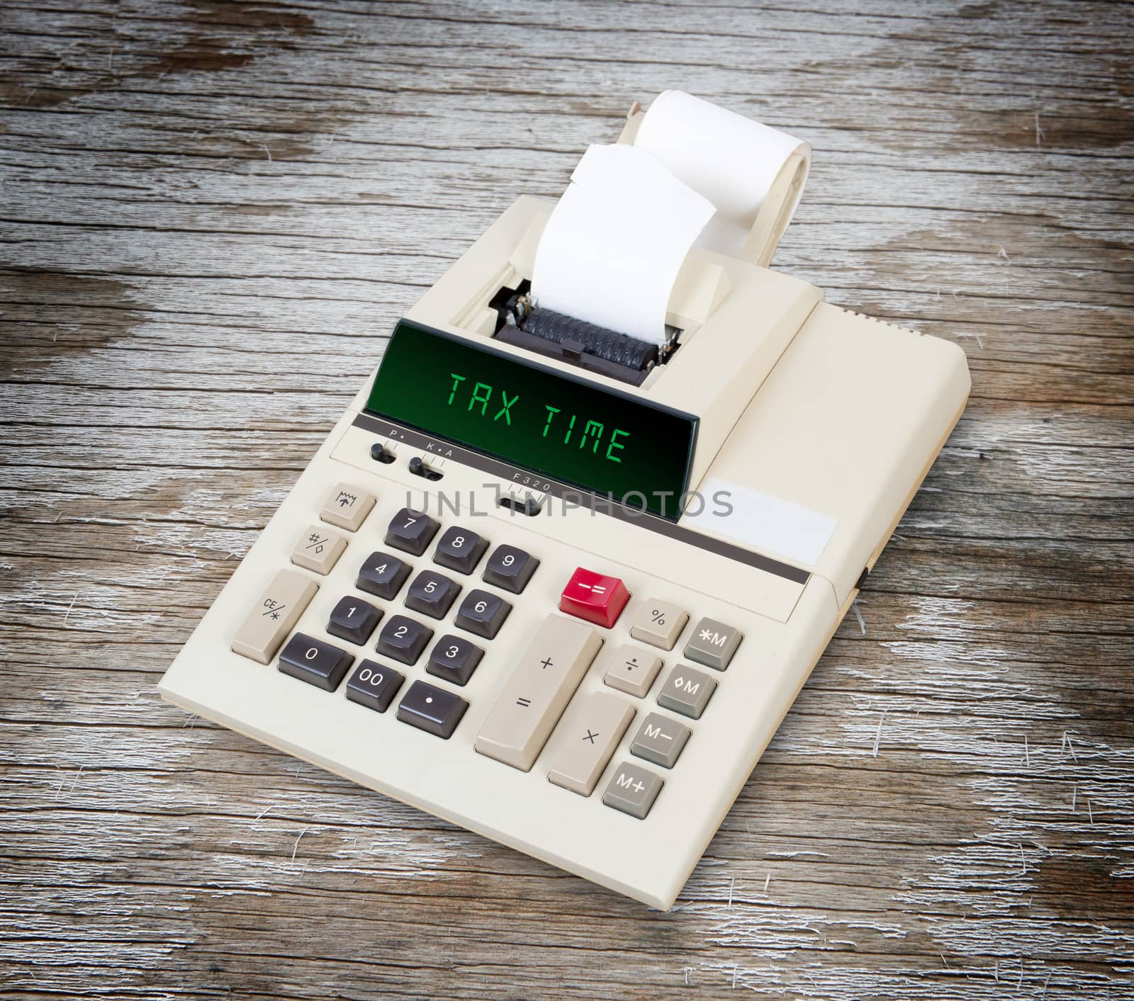 Old calculator showing a text on display - tax time