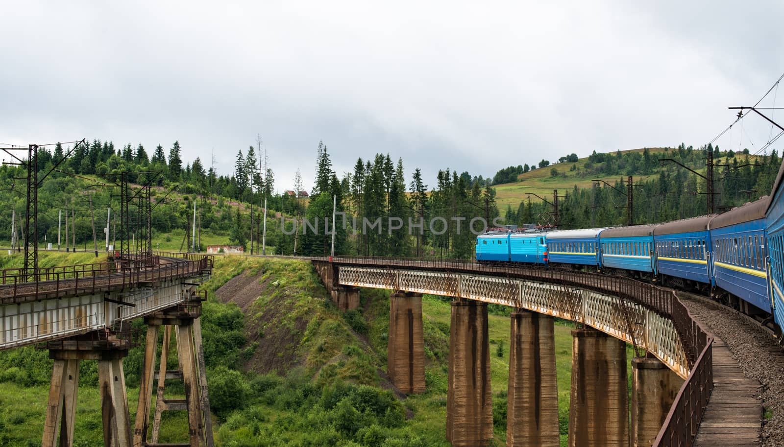 Passenger train going across the bridge in the Carpathian Mountains