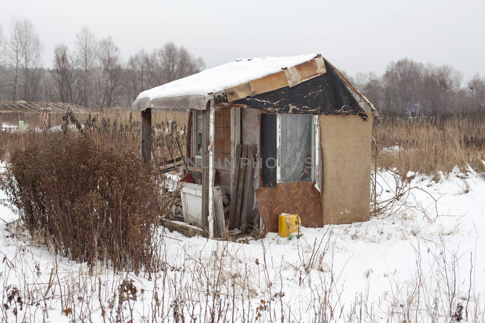 Temporary self-made shelter covered with the snow in winter.