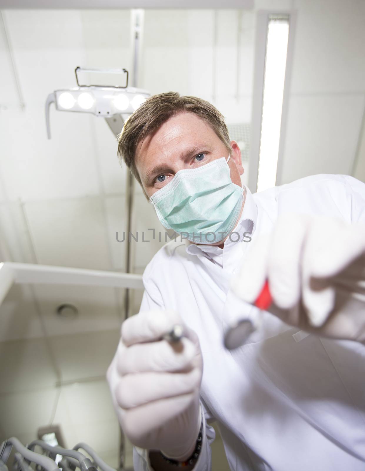 Dentist in action by gemenacom