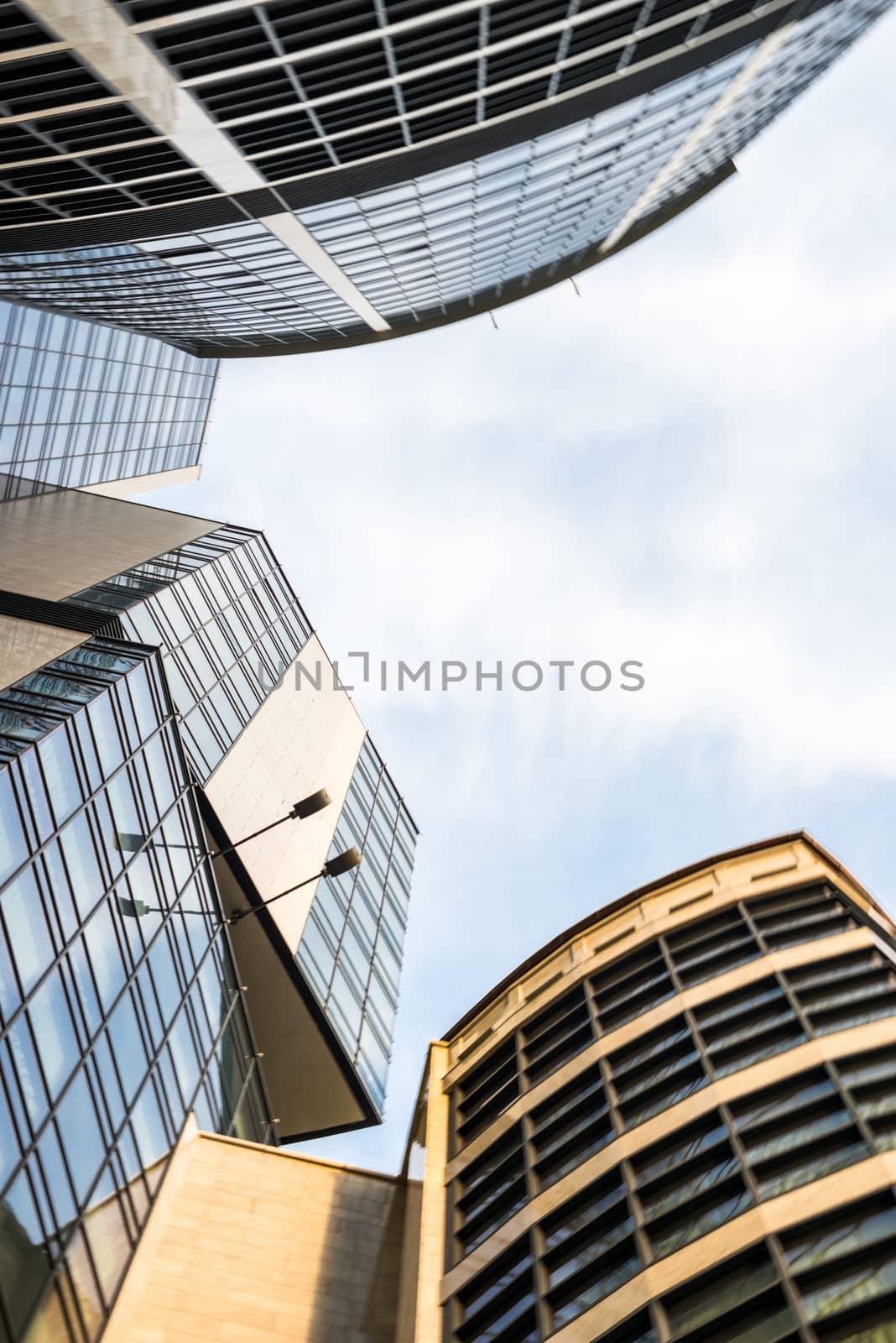 Modern high-rise buildings with glass wall surfaces.
