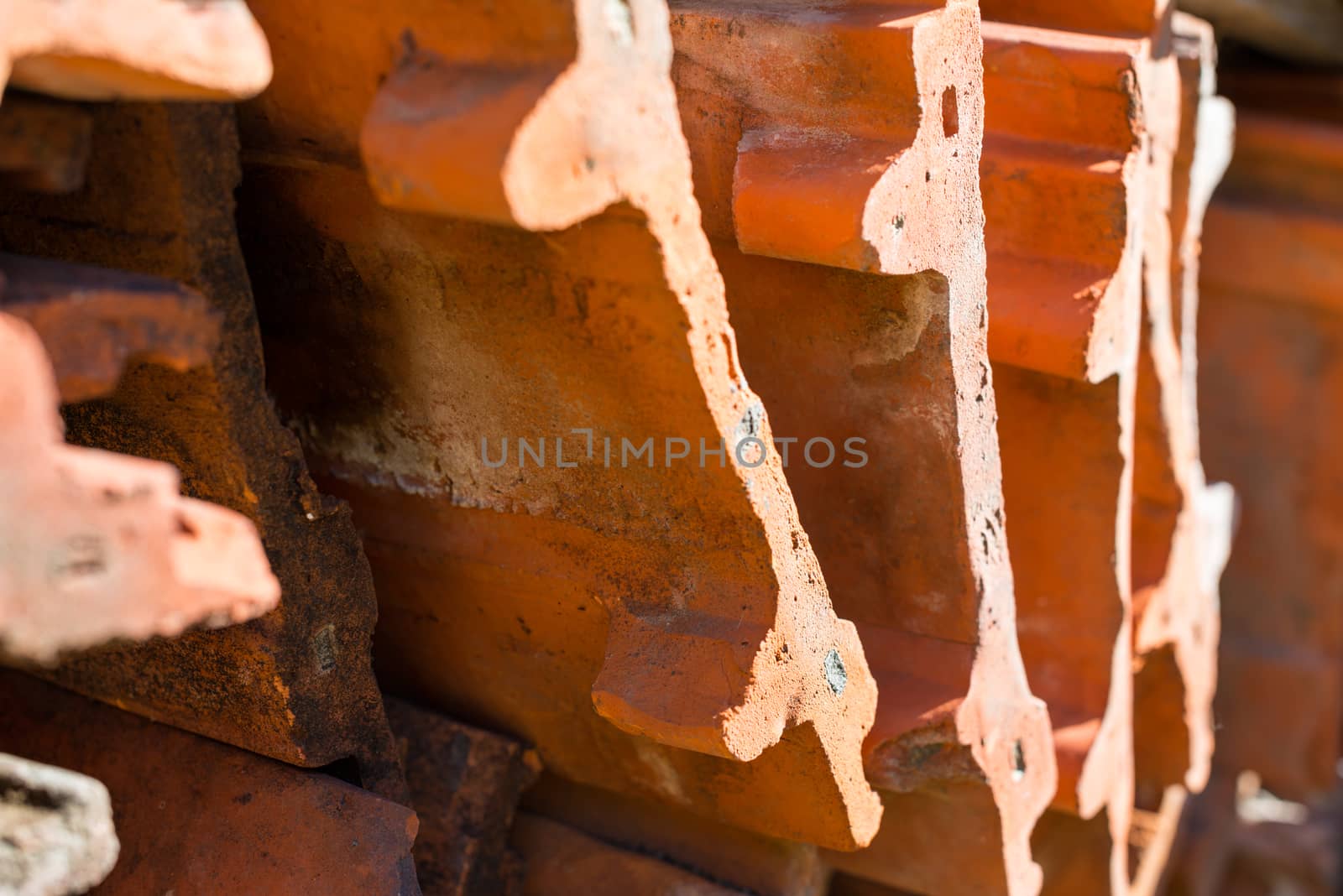 Stack of the orange roof tiles. Close up.