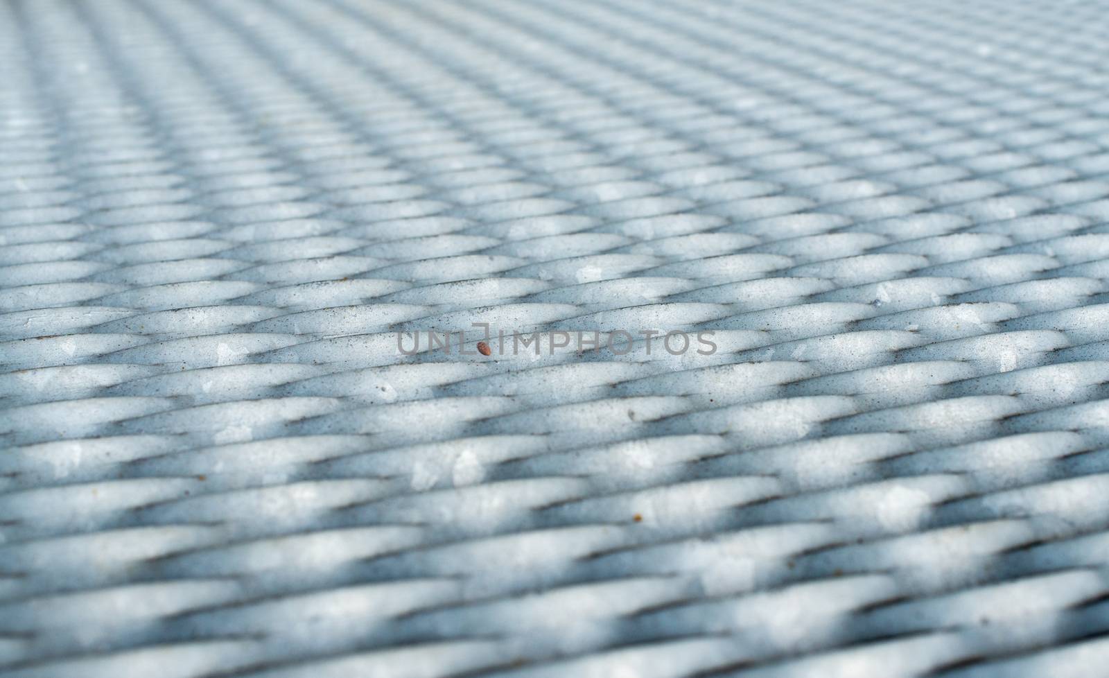 The gray metal mesh surface. Close up.