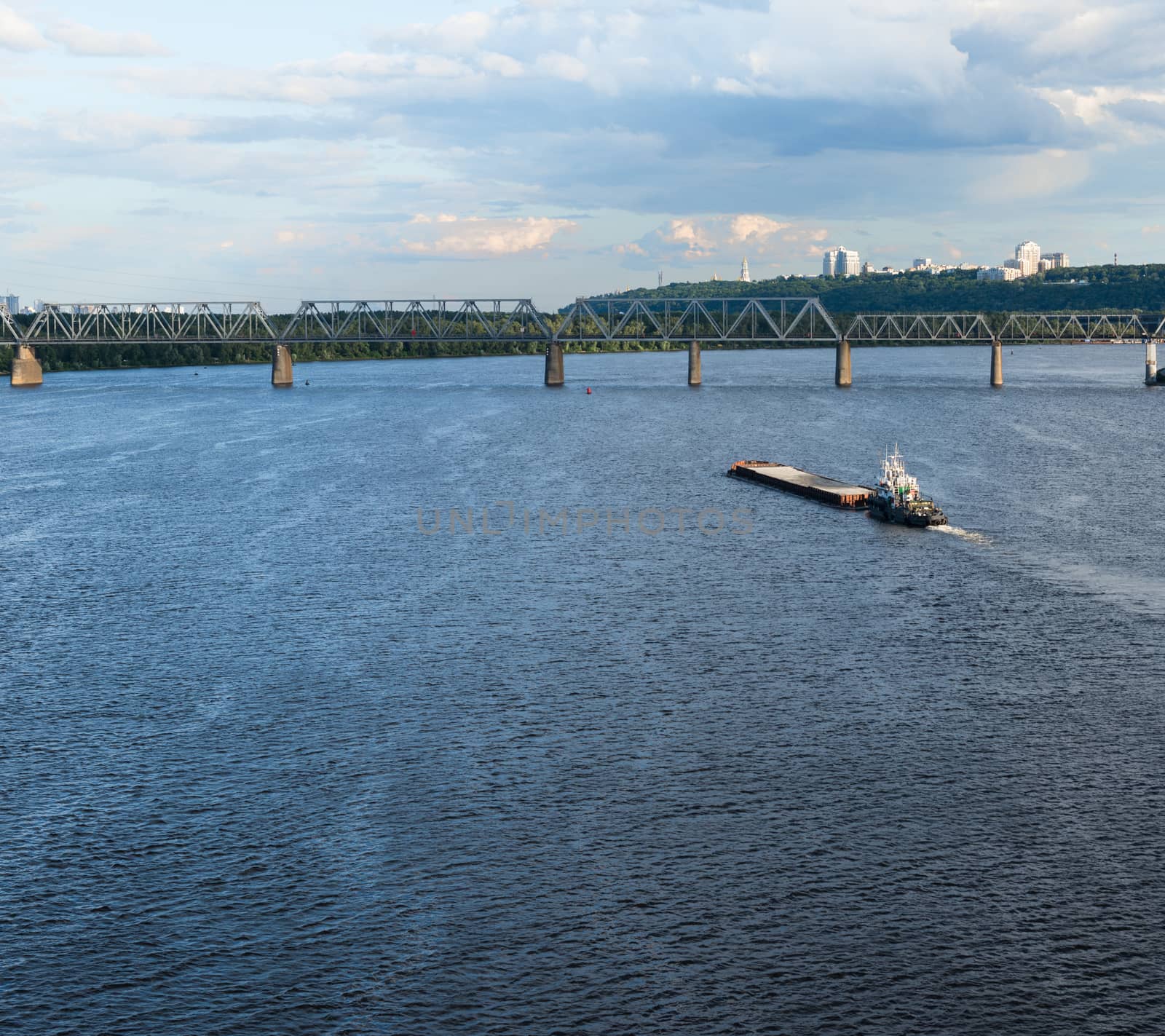 The barge floating in the blue Dnieper waters by rootstocks