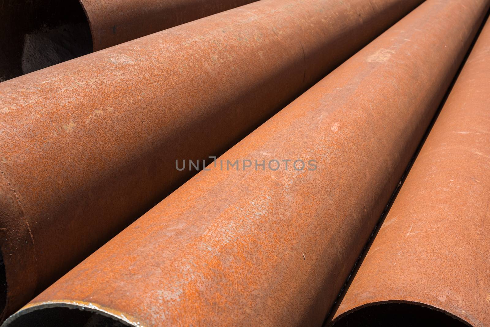 Rusty metal pipes stack by rootstocks