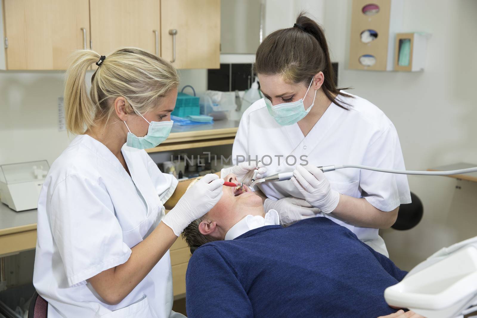 Dentist and nurse working with a patient