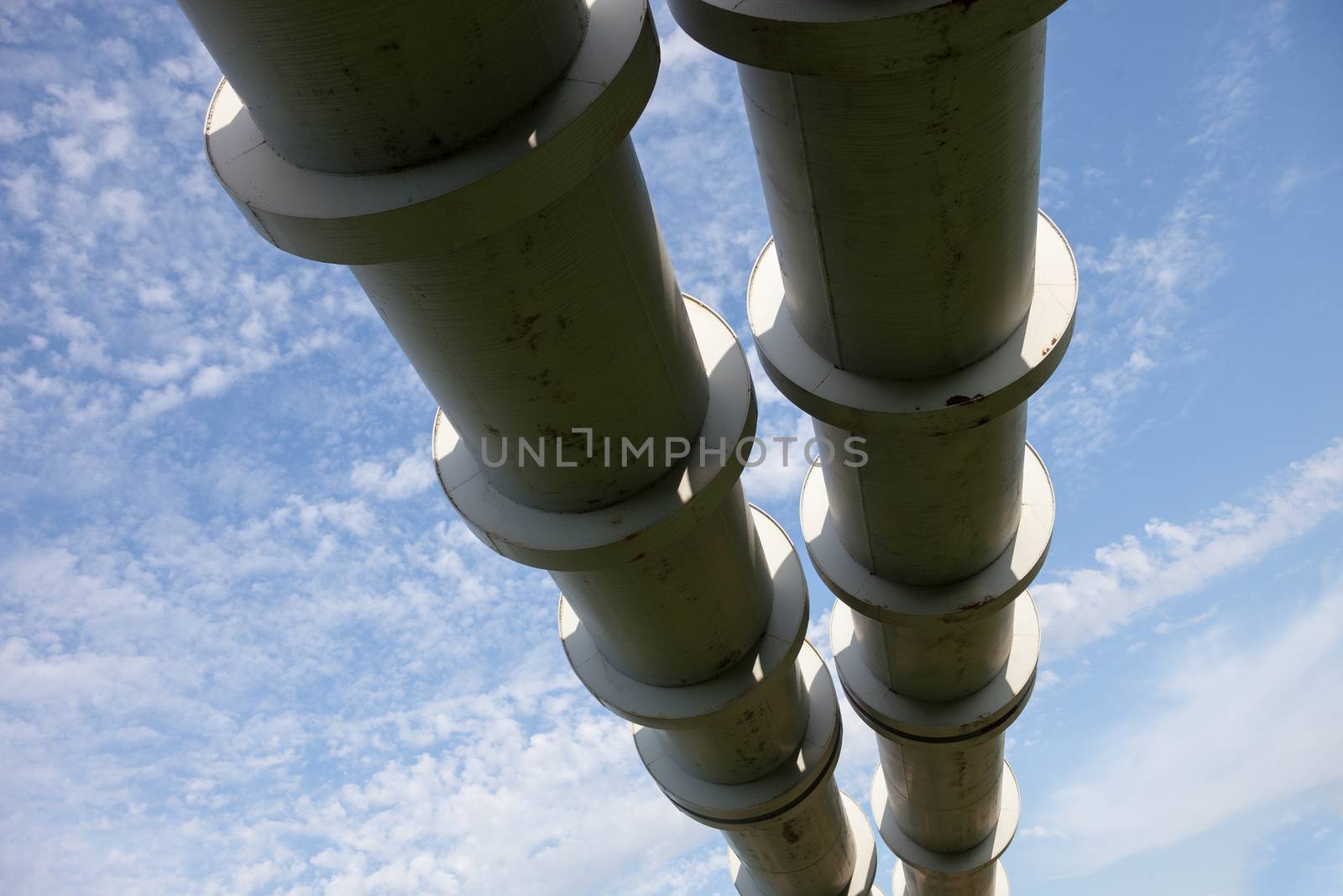Elevated section of the pipelines against the cloudy sky