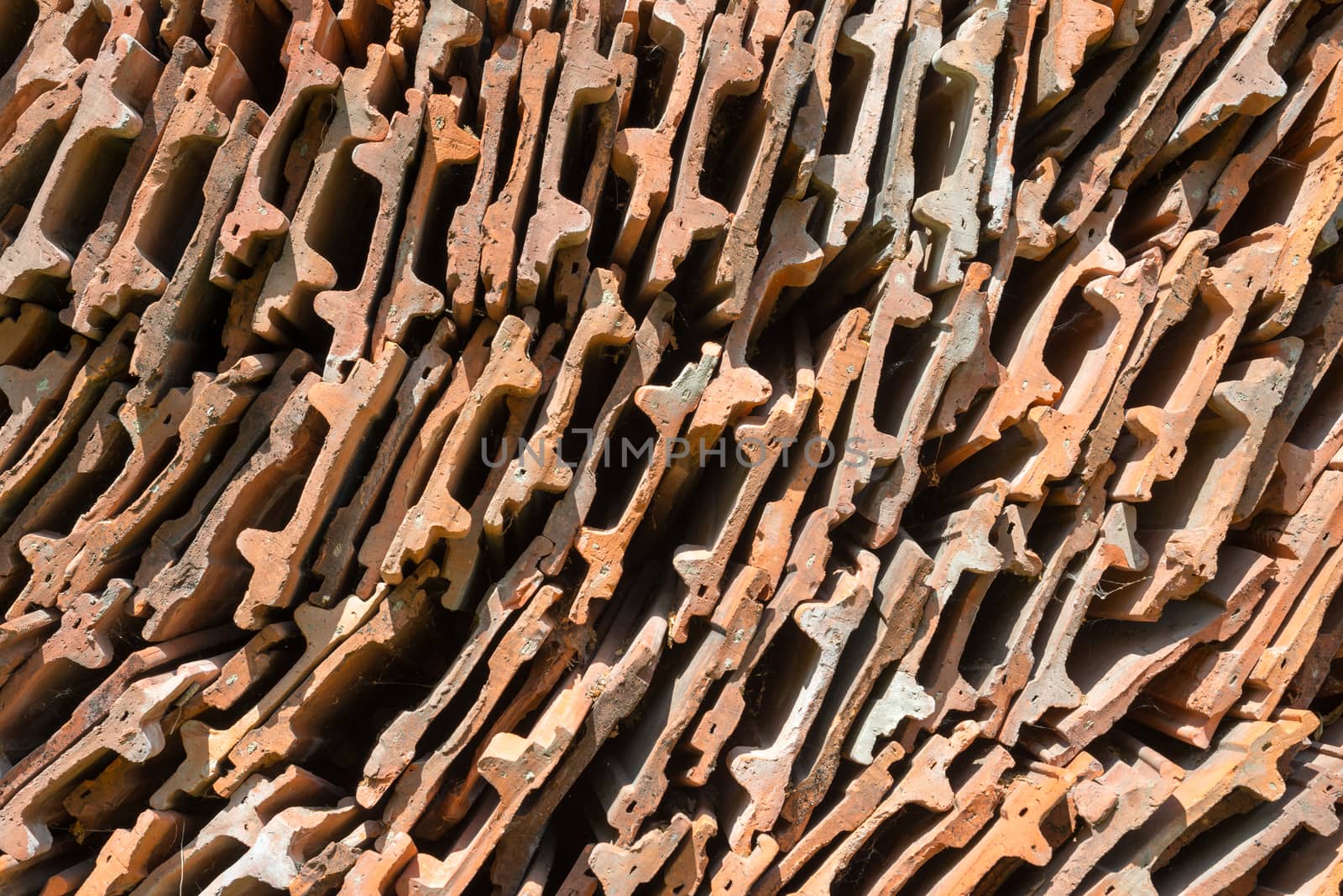 Stack of the orange roof tiles by rootstocks