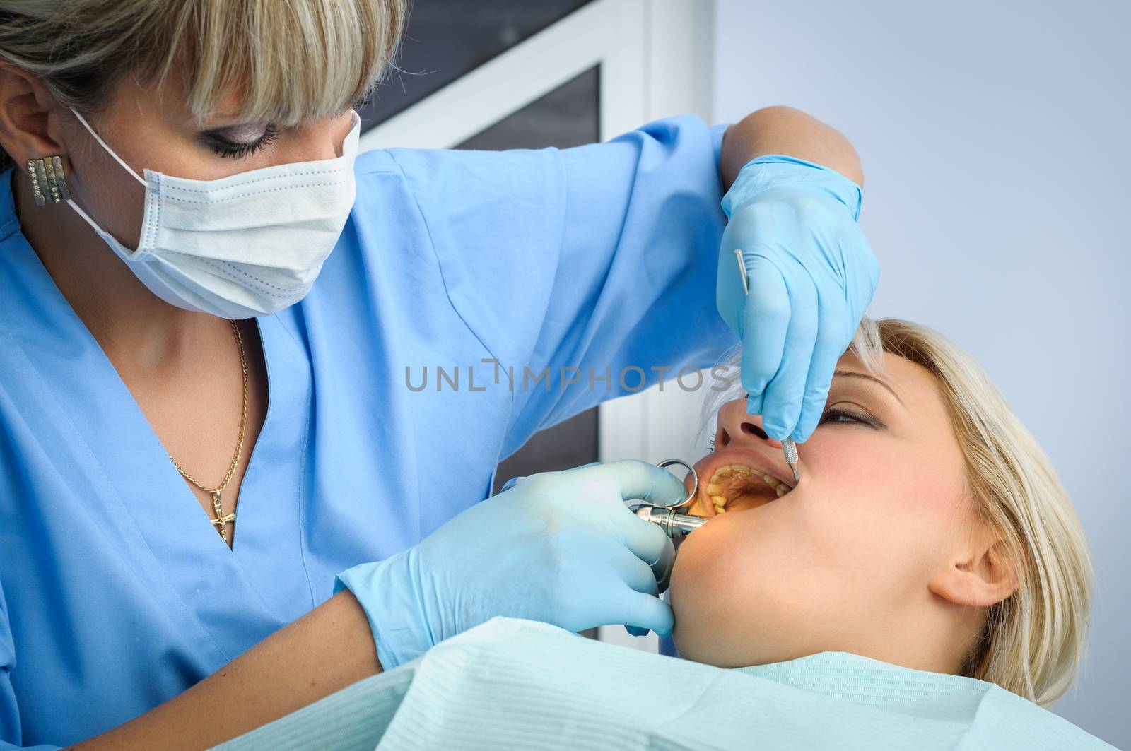 female dentist at work, anaesthesia injection before cavity stopping