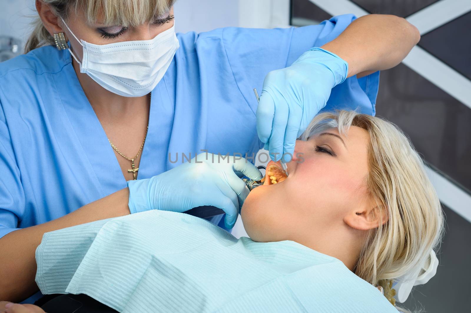 female dentist at work, anaesthesia injection before cavity stopping