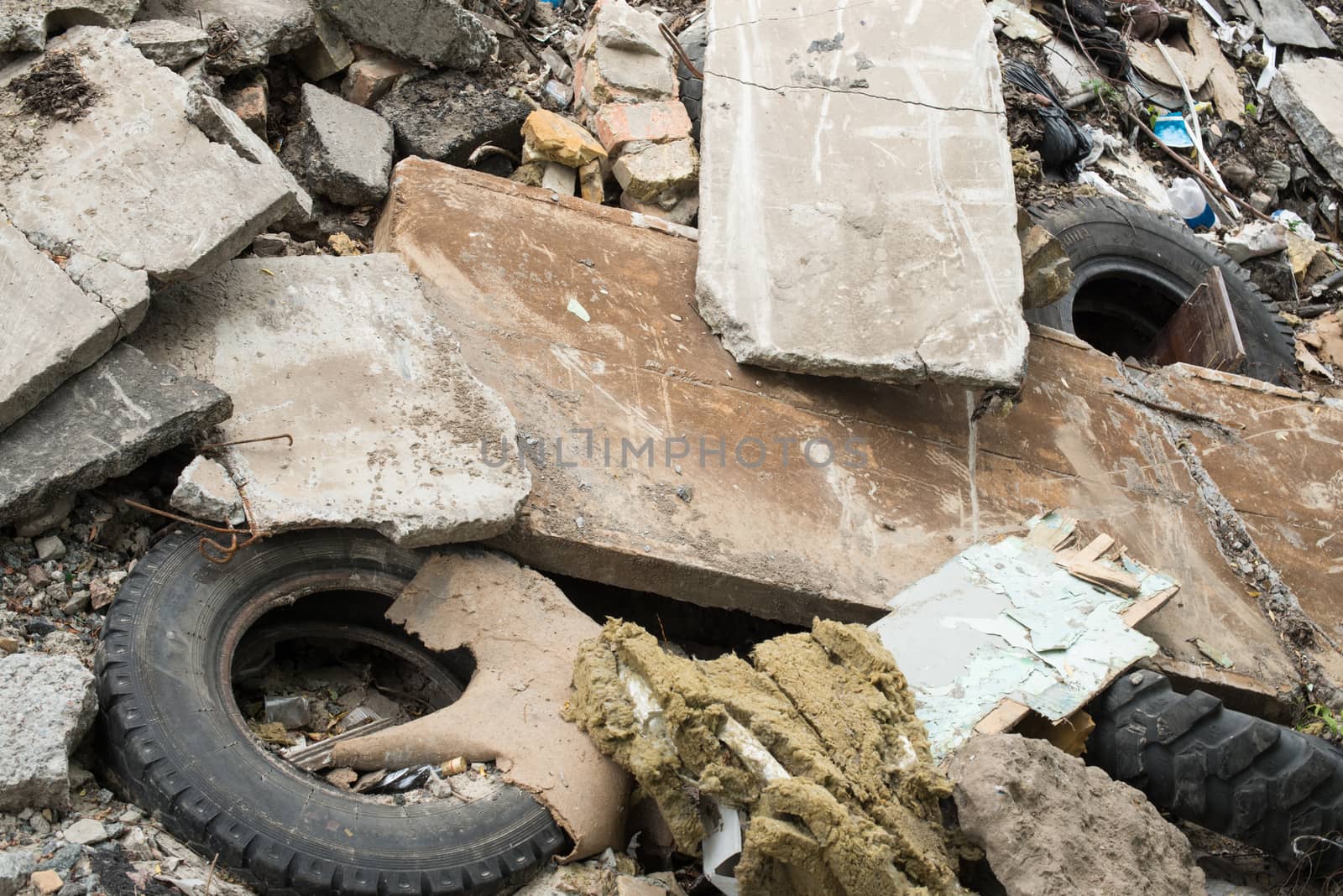 Industrial garbage. Heap of the damaged concrete blocks, old tires and other rubbish
