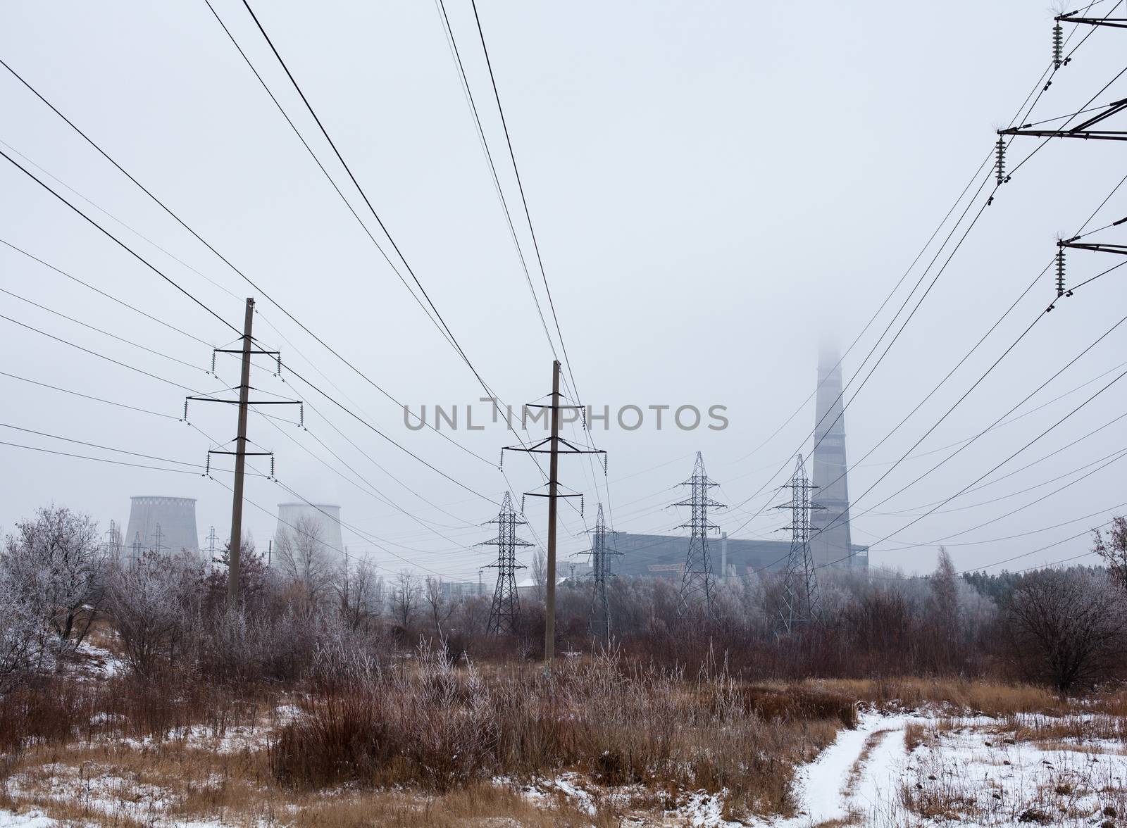 Electricity pylons, power lines, smoke stack and cooling tower of the cogeneration plant near Kyiv (Ukraine).