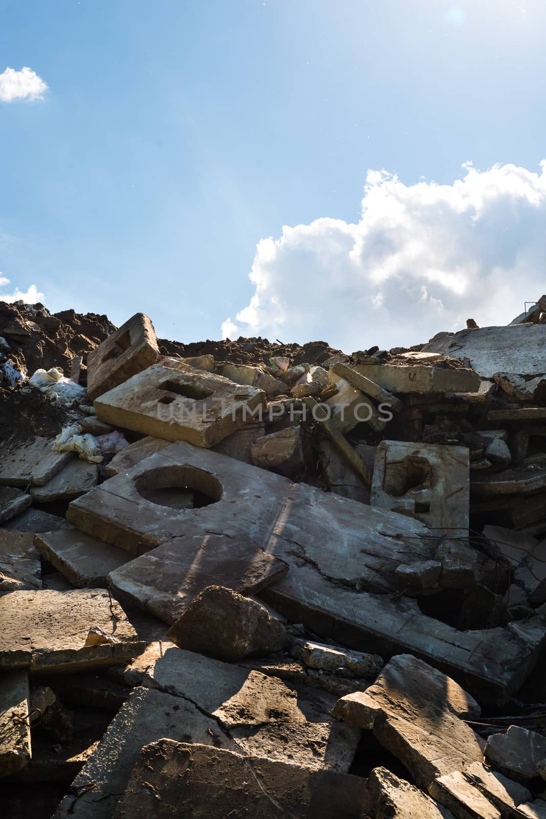 Heap of the damaged concrete blocks by rootstocks