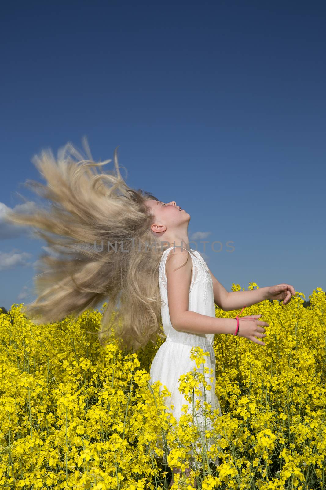 Young girl with Long Hair on a Rape Field