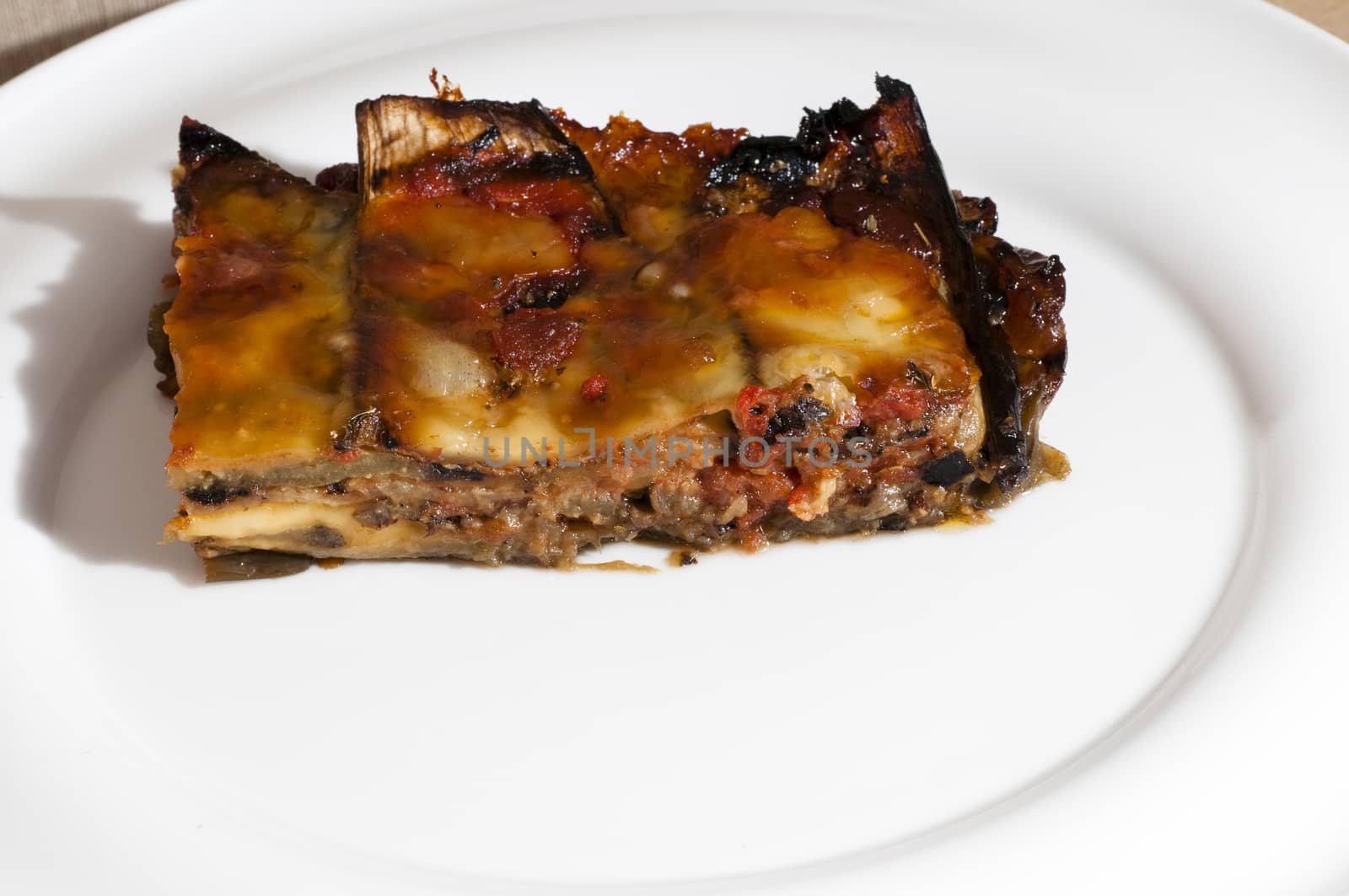 delicious eggplant parmesan served on a white plate